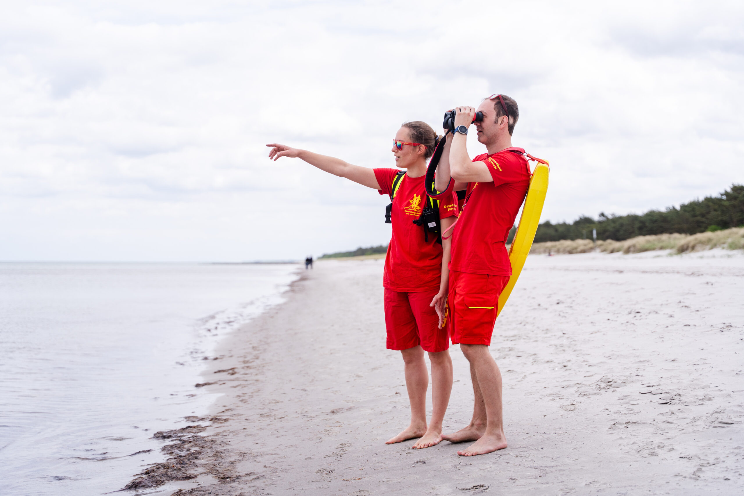 The lifeguards gaze out at the sea and keep watch over the beach and its visitors.